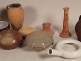 many different types of vases sitting on a table