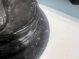 a statue of a person holding a dog on a pedestal
