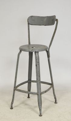 an image of a metal stool with a wooden seat and back