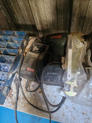 an image of a drill and other tools sitting on a table