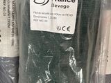 many rolls of fabric wrapped in plastic bags on a shelf
