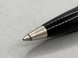 a black pen with a silver tip sitting on a table