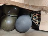 a box full of helmets and helmets sitting on the floor