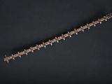 an old silver metal object on a black surface