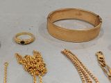 a lot of gold jewelry sitting on a table