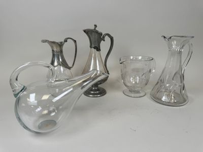 three glass vases and a glass pitcher on a table