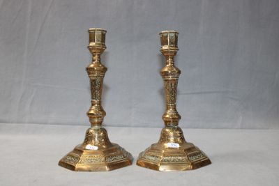pair of antique brass candlesticks on a white background