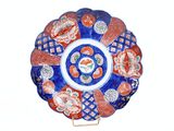 a blue and red plate with a flower design on it