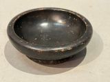 a small black bowl sitting on a table