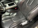 a black leather car with a steering control in it