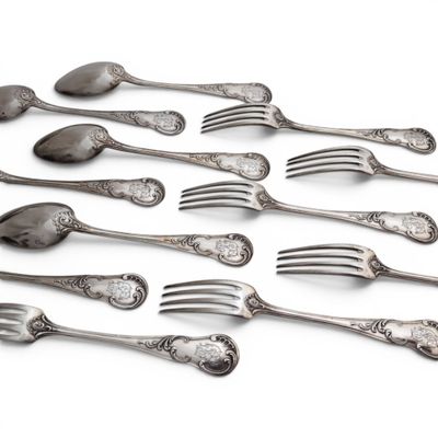 a lot of forks and spoons on a white surface