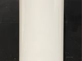 a white water heater sitting on a tiled floor