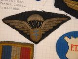 several military patches are displayed on a piece of paper