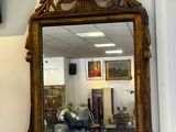 a mirror hanging on the wall in the corner of a room