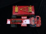 two toy trucks that are sitting on a black surface