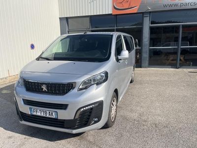 the silver van is parked in front of a building