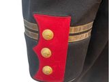 the back of a military uniform with a red and black stripe