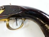 a gun that is on display on a white surface