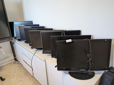 a lot of tvs that are sitting on top of the cabinets