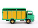 a green and yellow toy truck on a white surface