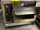 an oven that is sitting on a table in a kitchen
