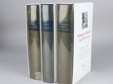 two books in a white box on a gray surface