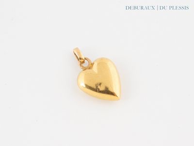 gold plated heart charm on a white background