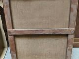 a wooden cabinet with two drawers on top of it