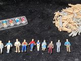 a lot of small toy figurines and a remote control
