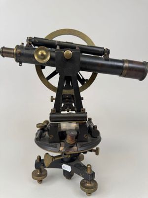 an antique brass and black telescope on a tripod stand