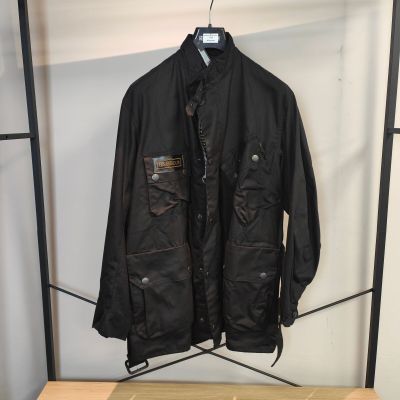 une veste noire suspendue à un portant dans une pièce