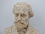 statue of a man with a beard wearing a suit and tie