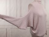 an image of a woman wearing a pink sweater