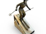 bronze statue of a man skiing on a ramp with ski poles