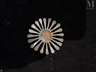 sterling silver broochle with pink stone in center on black background