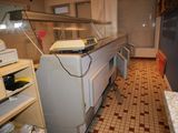 an image of a kitchen with a counter and a refrigerator