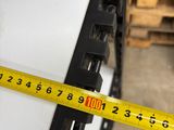 a yellow tape that is measuring the width of a piece of paper