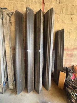 several pieces of metal are stacked on top of each other in a garage