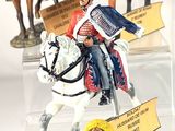 many figurines of men riding horses in a display case