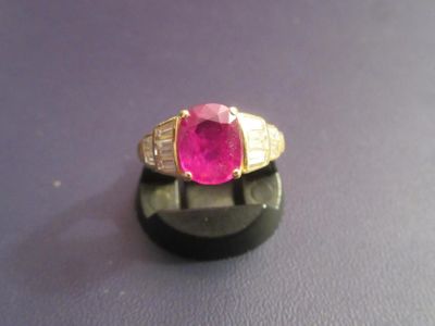 an image of a ring with a pink stone in it