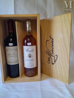 two bottles of wine in a wooden box on a bed