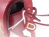 a red purse with a tag attached to it