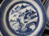 blue and white plates with designs on them on a table