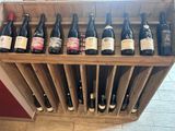 many bottles of wine in a wooden wine rack