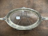 a silver tray with a glass lid on a table