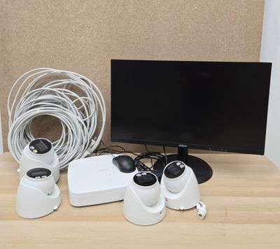 a desk with a monitor, mouse, and other electronics on it