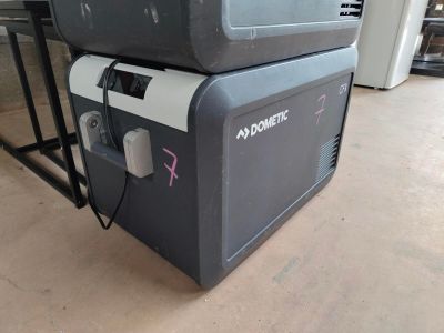 two coolers stacked on top of each other on the floor