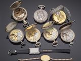 several different types of pocket watches on a black surface