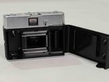 a camera that is open on a white surface