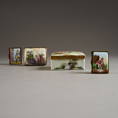 three small porcelain boxes with pictures of people on them sitting next to each other